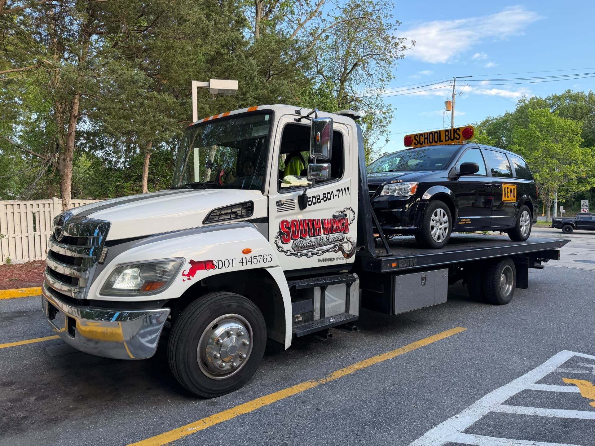 South Winch flatbed tow truck transporting a vehicle